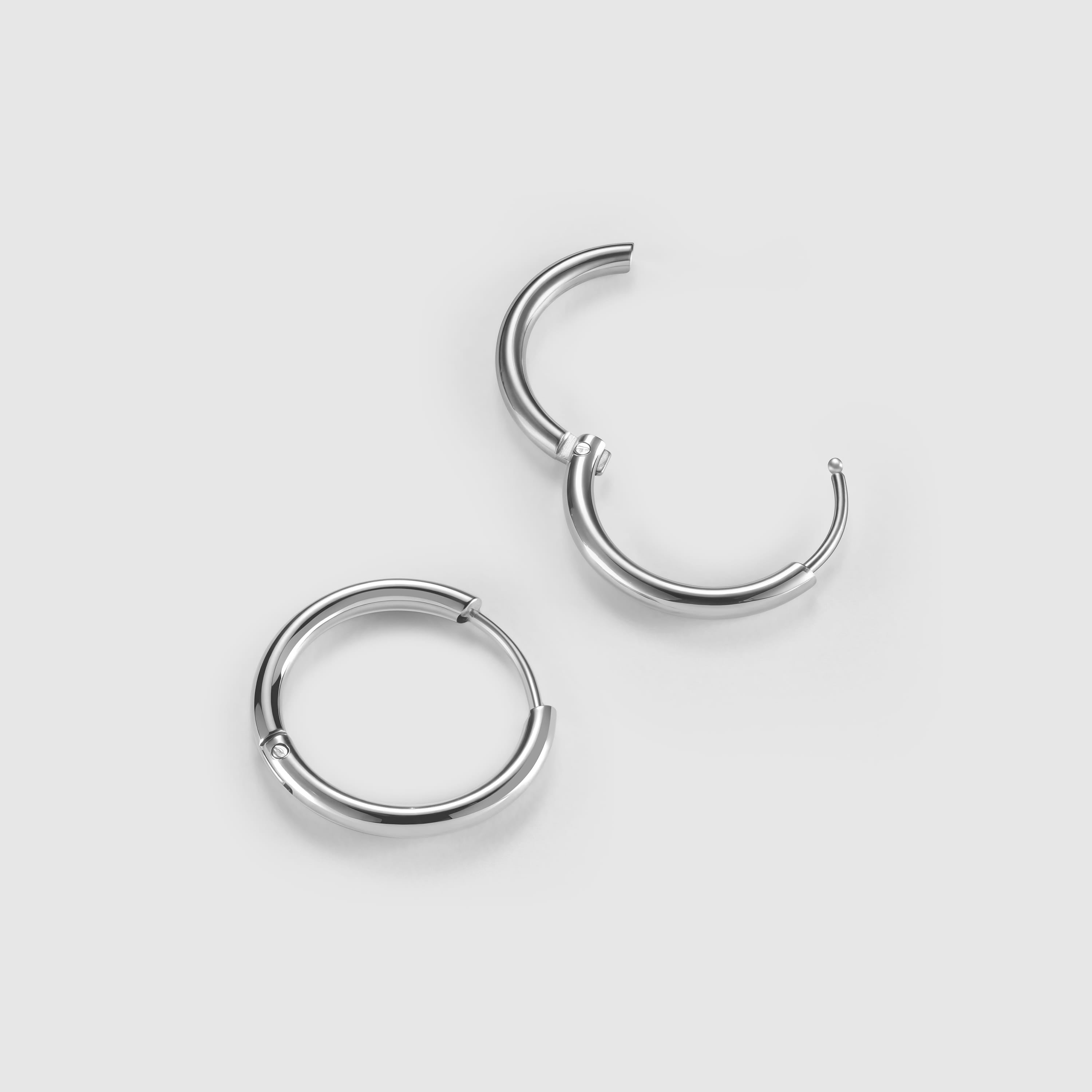 Pair of silver hoop earrings on a light gray background