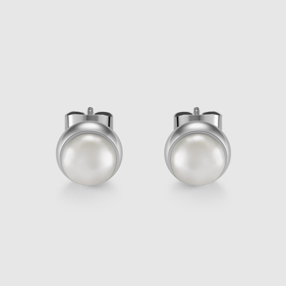 Pair of pearl earrings on a light gray background