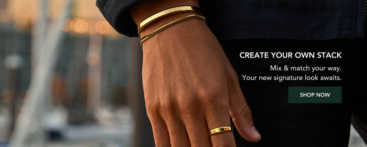 Gold-toned bangle bracelet worn on a wrist.