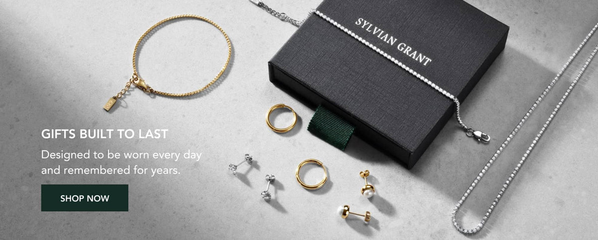 Gold-toned bracelet with a small rectangular charm hanging from its chain.