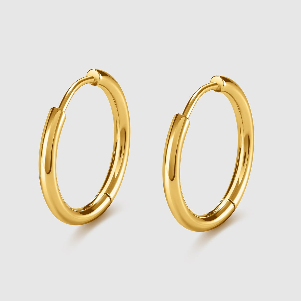 Gold hoop earrings on a light gray background
