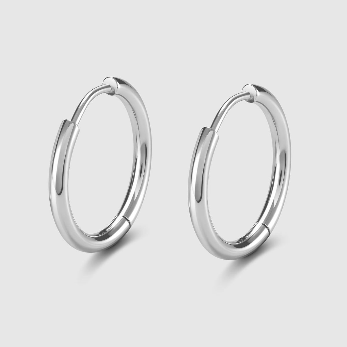 Pair of silver hoop earrings on a light gray background